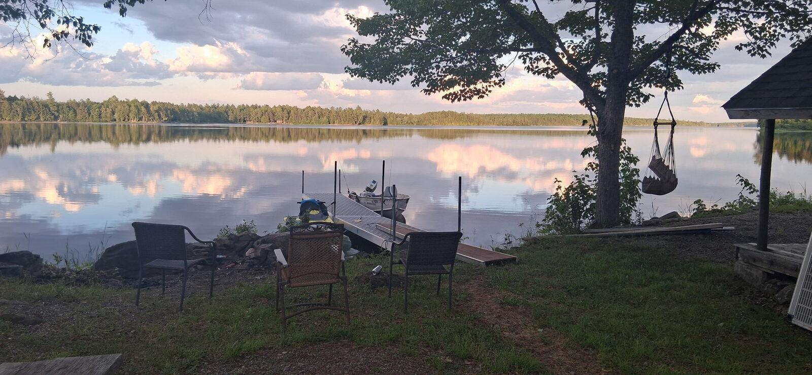 Lakeside fire pit and dock at dusk